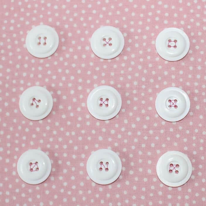 If your button has 4 holes you can sew it on crosswise or using parallel stitches.