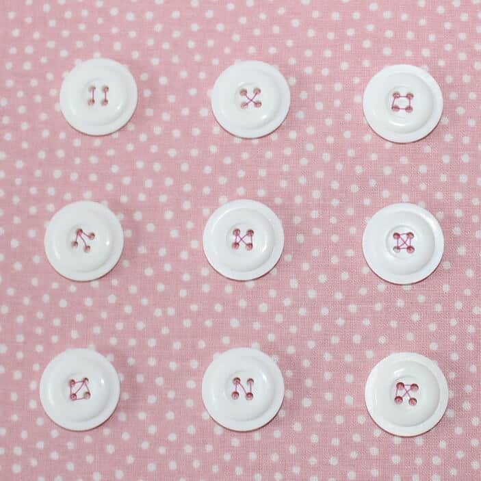 If your button has 4 holes you can sew it on crosswise or using parallel stitches.