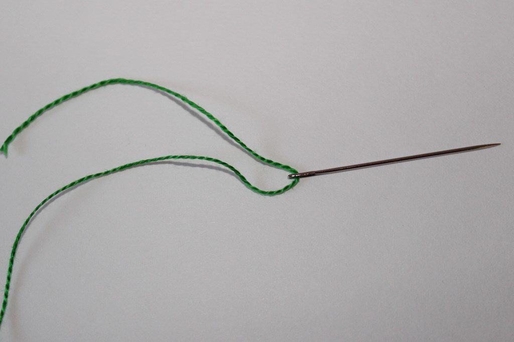 Needle threaded with a single thread