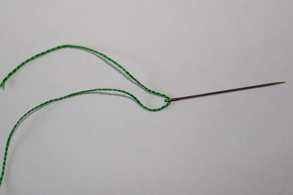 Needle threaded with a single thread