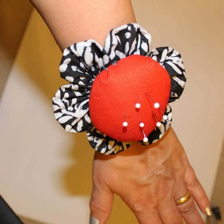 I recommend to make a wrist pincushion. image, link I found it to be very useful!