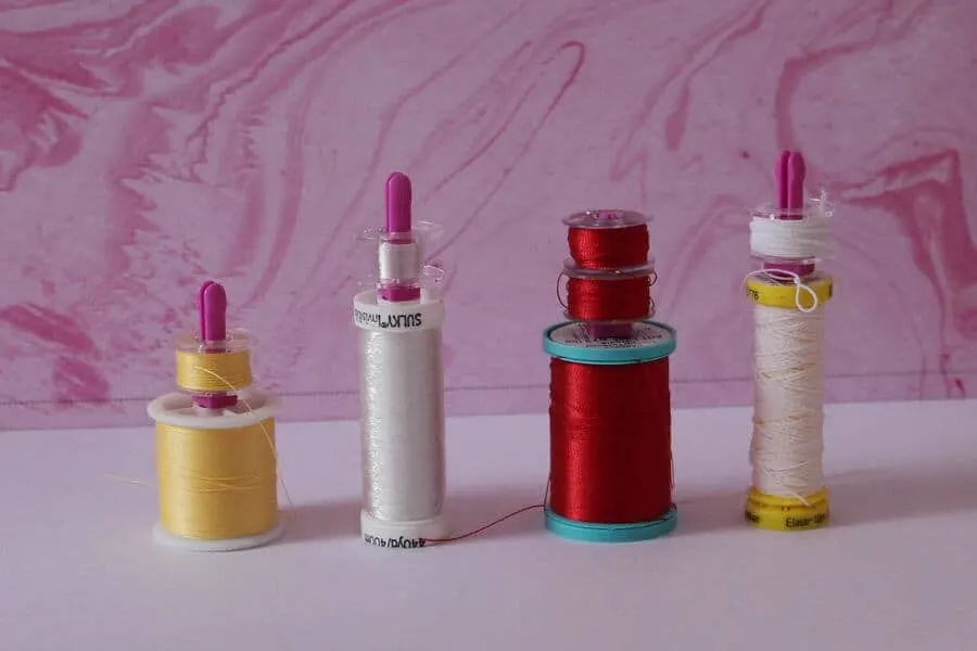 bobbin pegs hold bobbins, tutorial on how to thread a bobbin