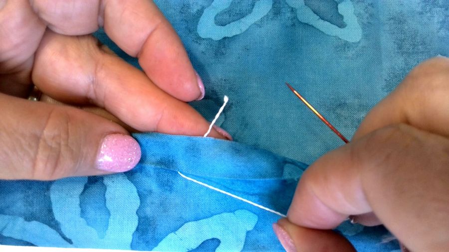 pulling thread through crease in fabric
