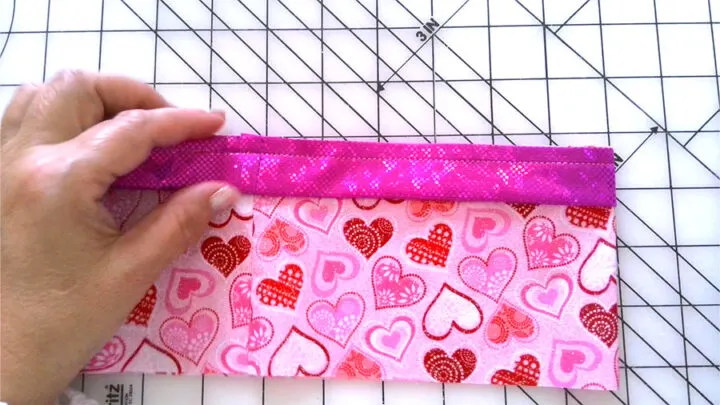 Attaching embellishment to the main fabric