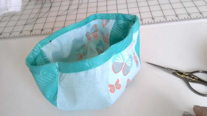 wrap the bias strip over the fabric edges of the pod. After that, press it.