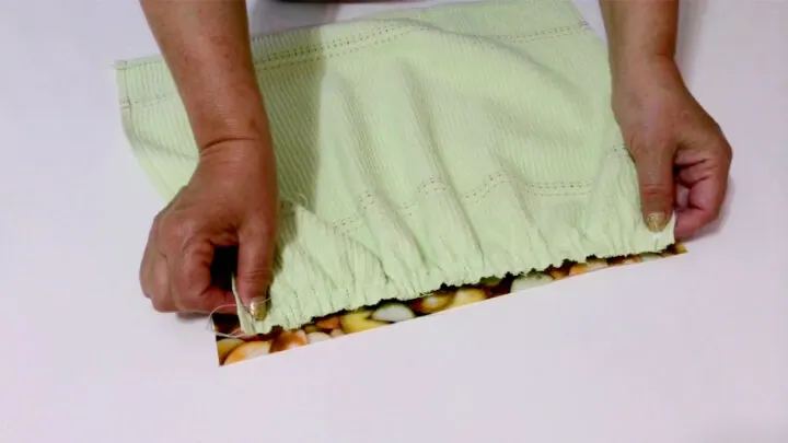 Gather the towel (by pulling the bobbin threads) and place the gathered edge on the fabric rectangle right sides together