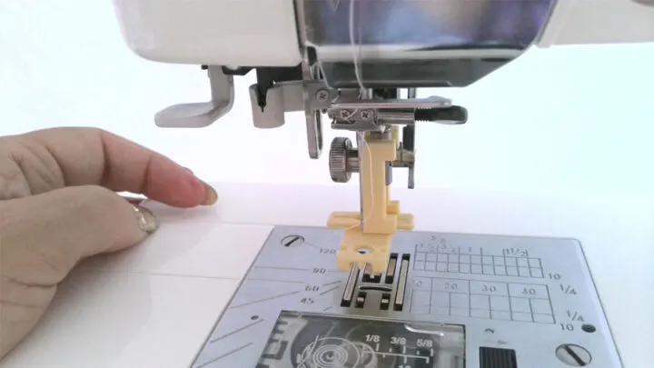 Manually move your needle up and down with the handwheel as you test to ensure the needle is in the right place and doesn’t touch the presser foot.