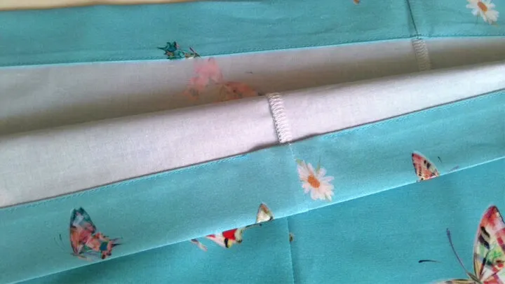 Make a regular straight stitch along the folded edge of the fabric.