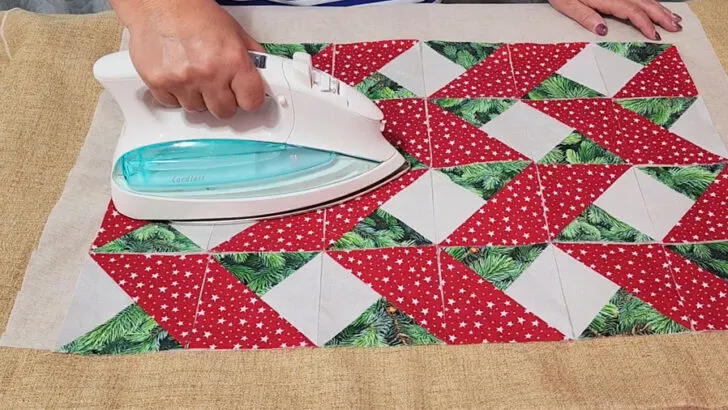 Simply press the iron down onto the fabric