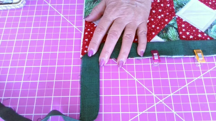 fold the binding strip up diagonally to form 45 degree angle