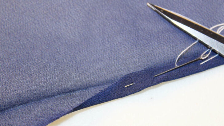 Fold the raw edge under to the hemline