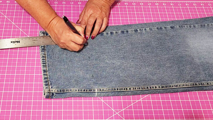 Measure the distance between the bottom of the jeans and the fold line that you marked while wearing the jeans