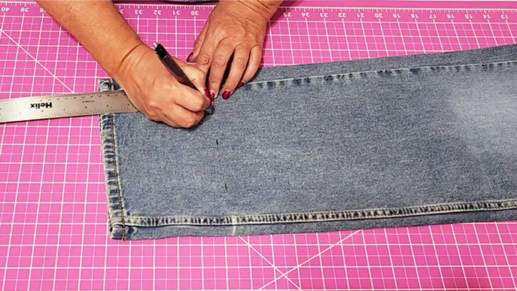 Measure the distance between the bottom of the jeans and the fold line that you marked while wearing the jeans