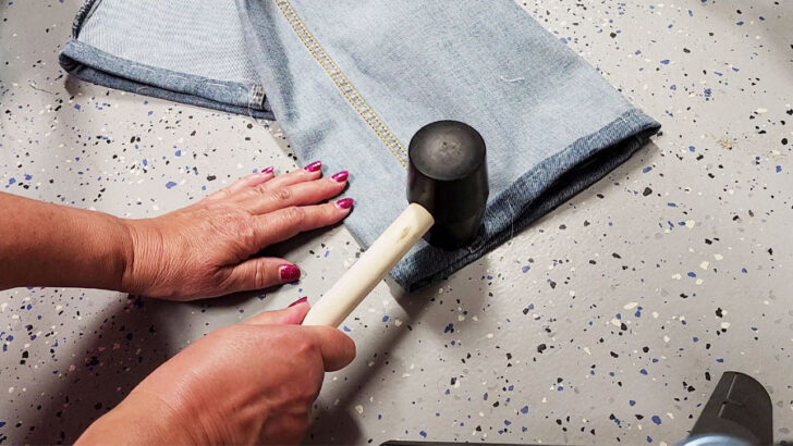 use a mallet (or a hammer) to flatten the seam