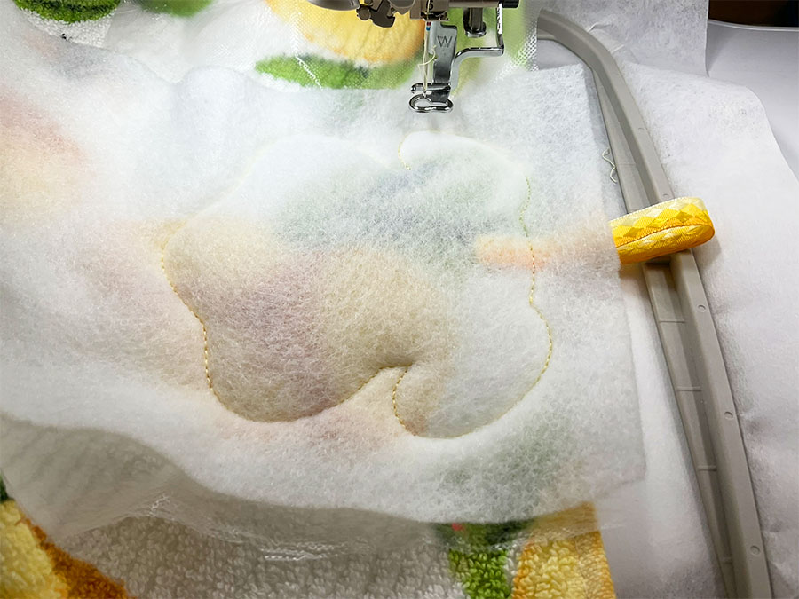 a piece of batting over the placement stitch on the towel