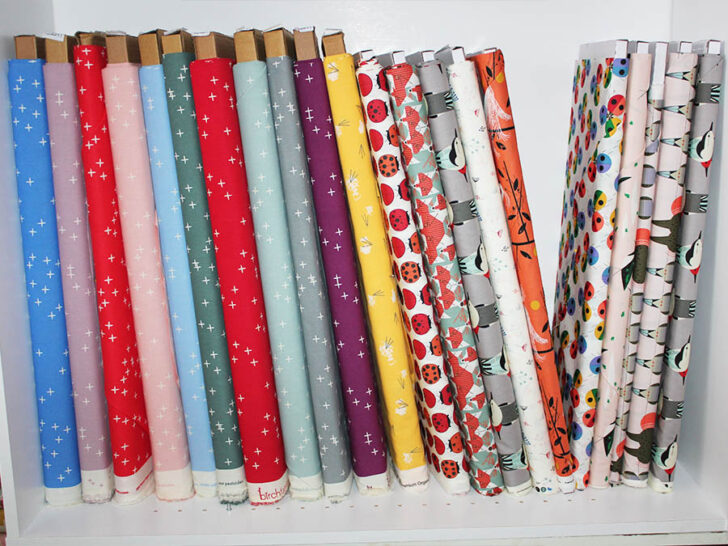 bolts of quilting cotton fabric on a shelf