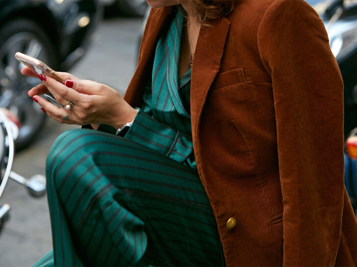 caramel brown jacket thrown over a deep teal set