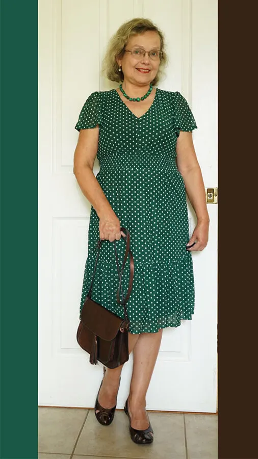 forest green dress paired with brown heels and a brown purse
