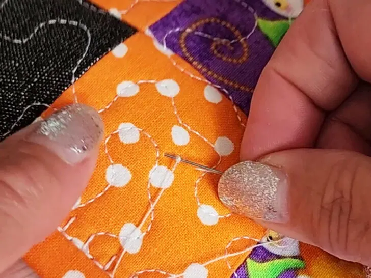 push the needle through the top fabric only into the batting