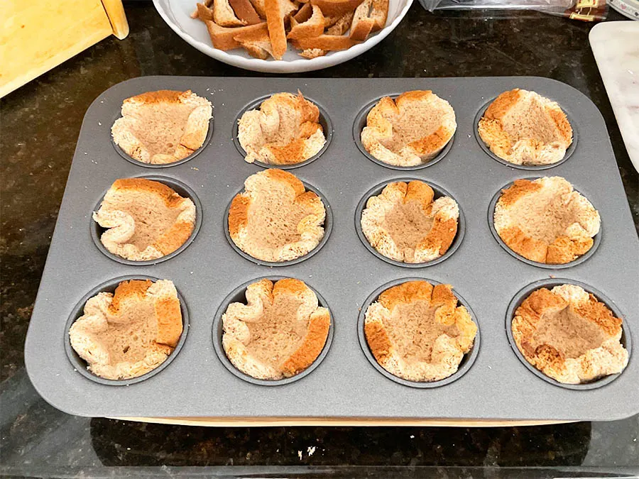 sliced bread place on a muffin pan
