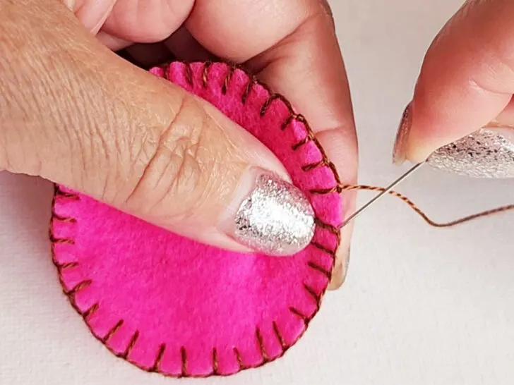 use your needle to go up under the vertical stitch on the very first stitch