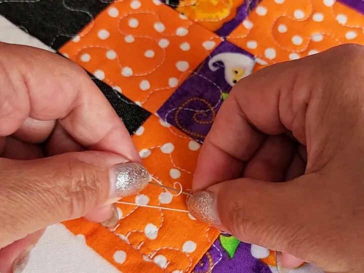 wrap the thread around the tip of your needle two or three times