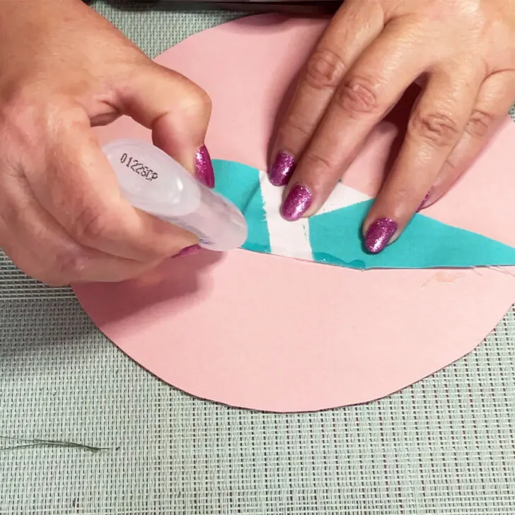Gently apply the fray-preventing glue along the raw edge of the fabric