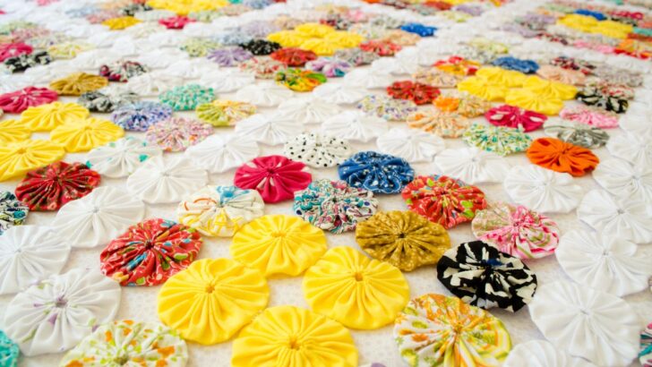 many fabric yoyos used to decorate a bedspread