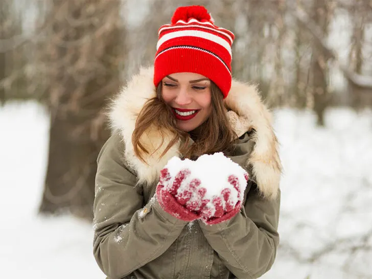 girl wearing a red beanie hat and red gloves