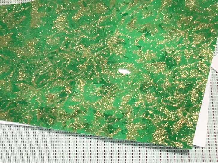 hole on a green fabric