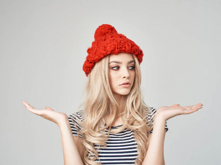 woman wearing a red unique beanie