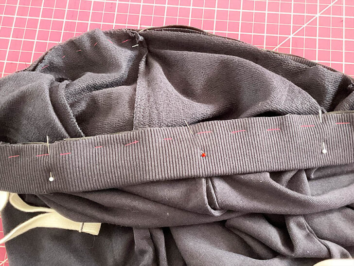 align the marks on the casing with the corresponding marks on the pants' waist