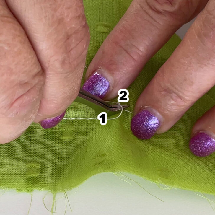 continue to pull on thread end 2 using the tweezers.