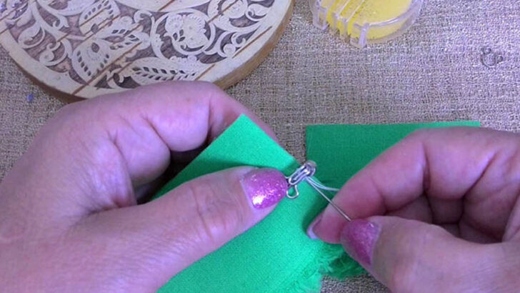 Sew a few small stitches right in the center of the hook's base