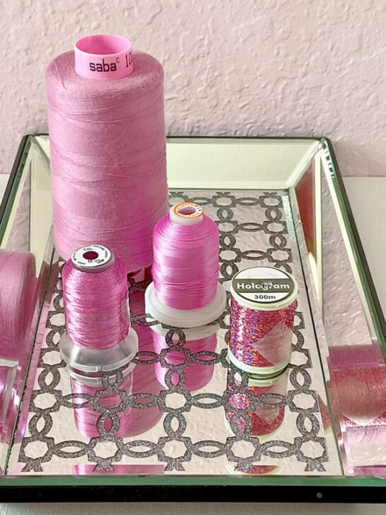 Assortment of pink sewing threads, showcasing a variety of shades from light pastels to bright pink