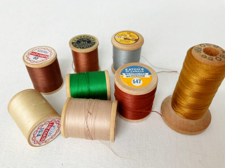 Assortment of various vintage sewing threads, showcasing a spectrum of colors and textures