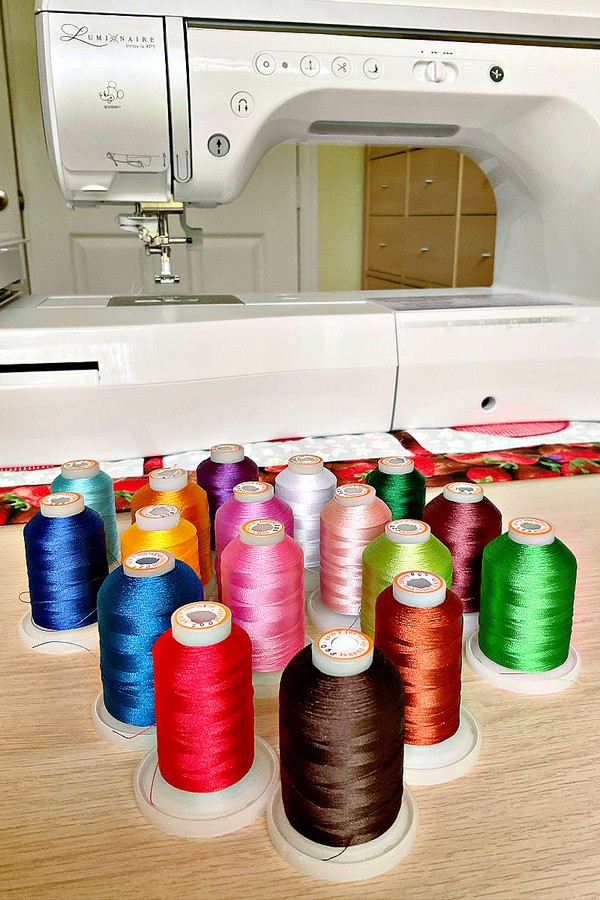 An assortment of threads in an array of vibrant colors and diverse materials, suitable for a variety of sewing and crafting projects