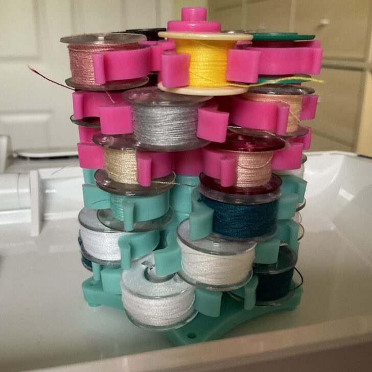 bobbin organizer in my sewing room filled with many bobbins