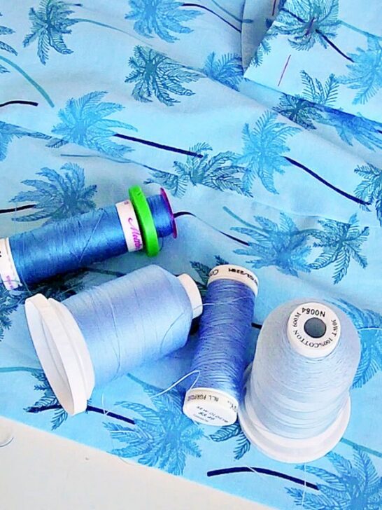 various shades of blue threads beautifully contrasted against a textured blue fabric background