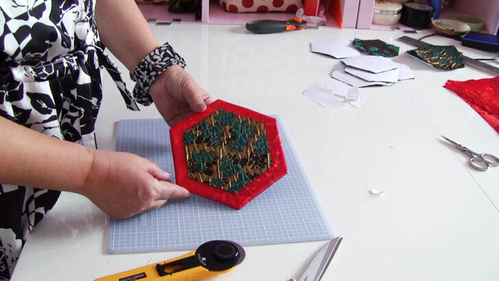 Center each applique over the turning hole of a main hexagon unit