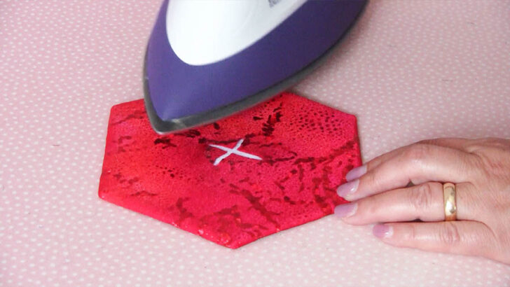 carefully press the edges of the center slit inward