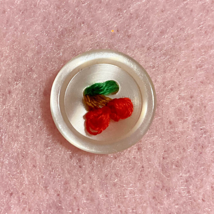 A button featuring a vibrant cherry design
