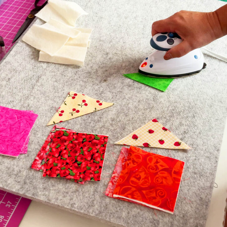 Fold your corner square with wrong sides together and press