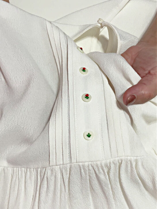 I embroider the stem in green floss on a button on my blouse
