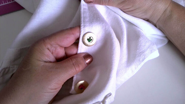 stem of a flower embroidered on a golden button