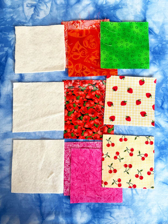 fabric squares of thin batting, base fabric and corner triangle