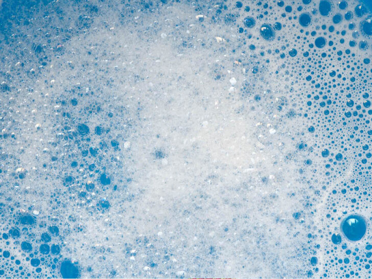 filled with bubbles, overflowing from too much detergent