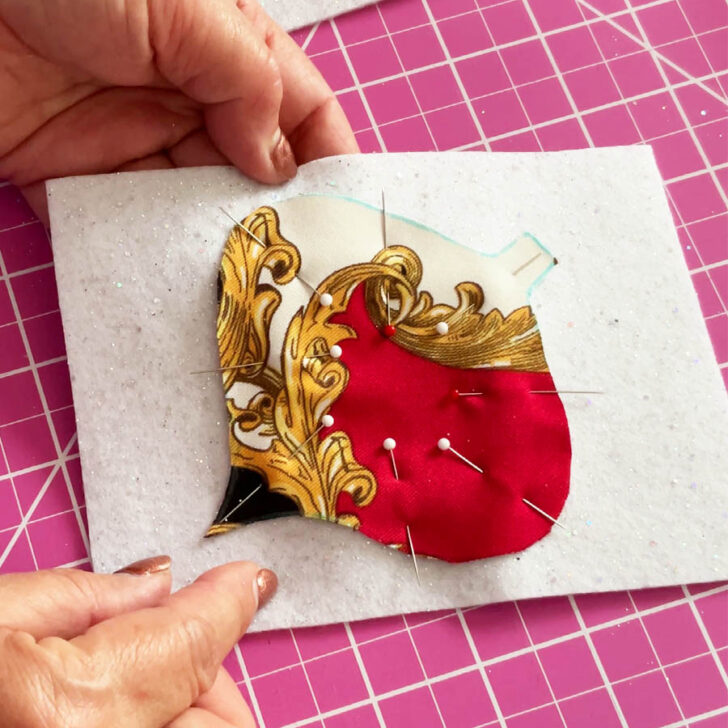 pin your cut fabric shape to the felt backing