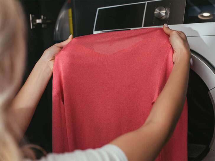 woman is inspecting her clothes