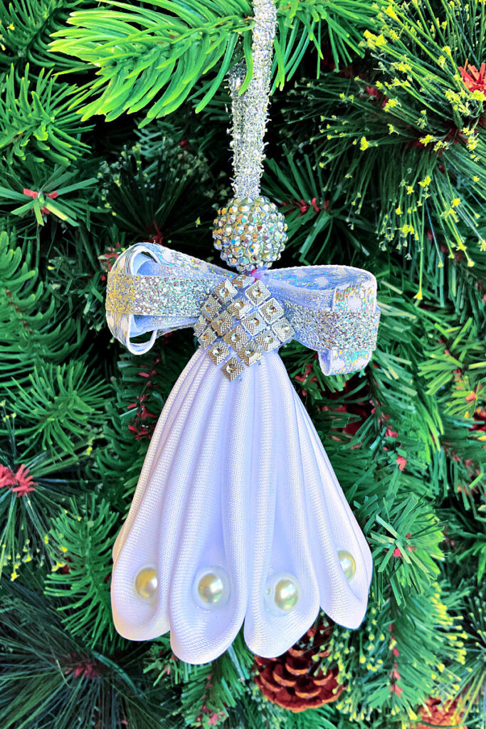 Homemade Christmas ornament - an angel made from white fabric with pearls.